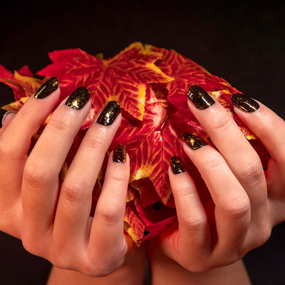 manicured hands holding leaves