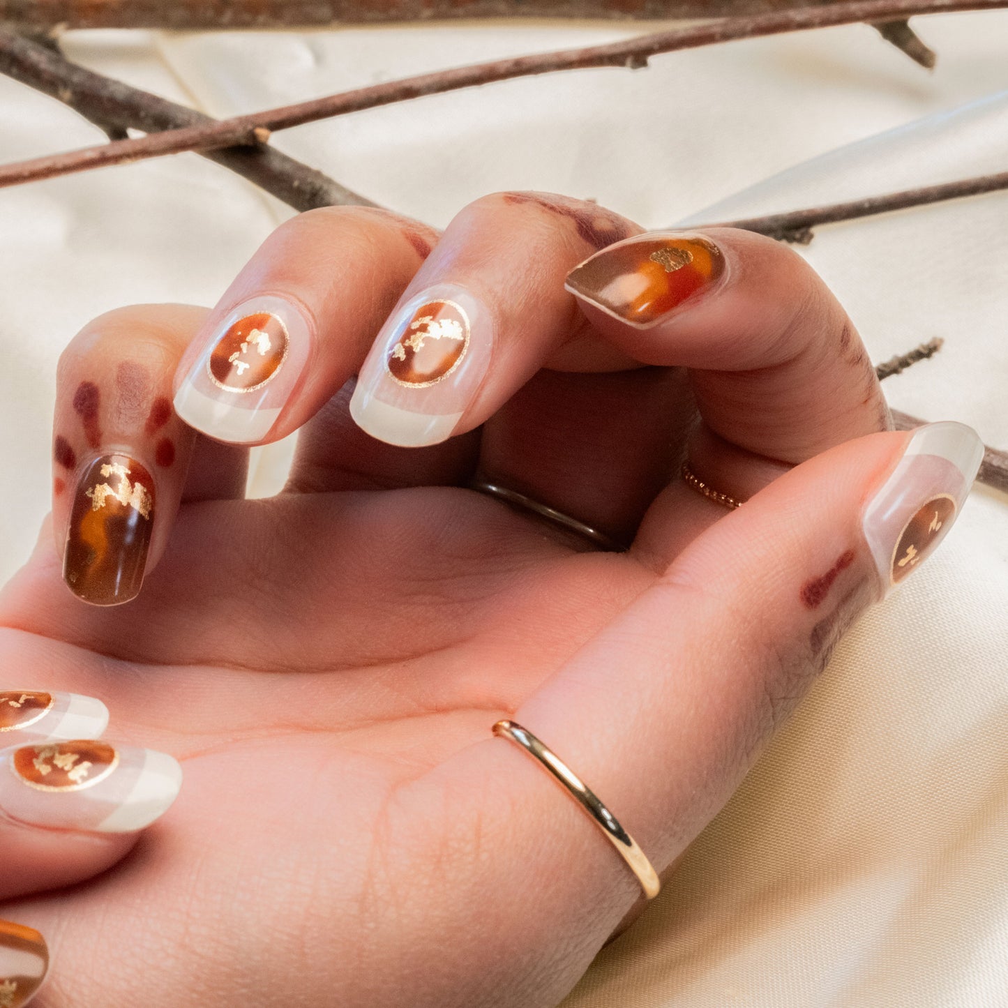 hand with manicured nails with tortoiseshell design