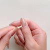 Removing a gel nail polish strip with a wooden stick